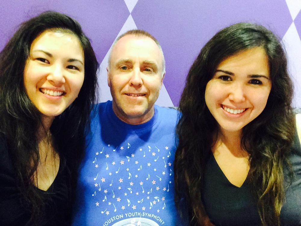 A NASA employee poses for a family photo with his two grown daughters.